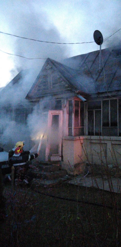O femeie s-a întors acasă când pompierii stingeau incendiul